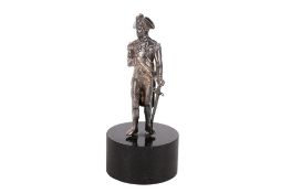 A silver model of Nelson on a stone plinth.