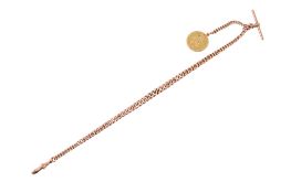 A George III guinea on a 9ct yellow metal watch chain.