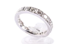 A platinum and diamond eternity ring. With 17 round cut diamonds, each circa 3.