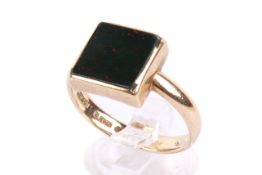 A 9ct gold and bloodstone panel ring. The panel of 1.1cm x 1.