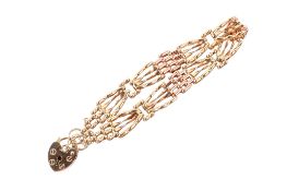 A two-tone 9ct gate bracelet. With hallmarked heart locket, hallmarked to end link, gross weight 8.