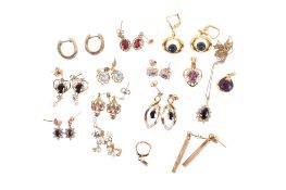 Eleven pairs of gold and yellow metal earrings and three pendants.