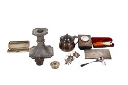 A small group of silver and metal table items.