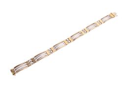 A two-tone 9ct gold bracelet. With bar links and 'screw head' motifs, hallmarked, L19cm, weight 22.