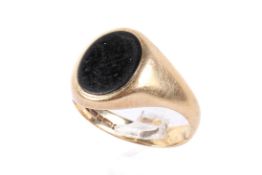 A 9ct gold and onyx sovereign ring. Hallmarked, size T/U, weight 5.9g.