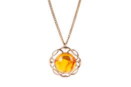 A 9ct gold and amber pendant.