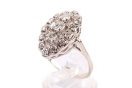 A white metal and diamond dress ring.