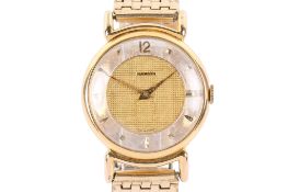 A yellow metal Marvin wristwatch.