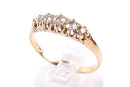 A yellow metal diamond ring.