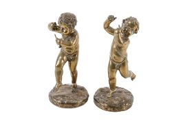 A pair of solid brass classical style sculptures of children. Raised on circular plinths (AF).