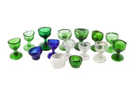 A collection eyebaths. Mostly glass examples in shades of green and blue. Max.
