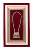 A decorative white metal pendant.