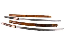 Two Burmese dha swords.
