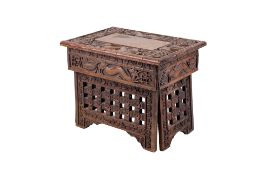 A small Chinese carved wood folding tea table.