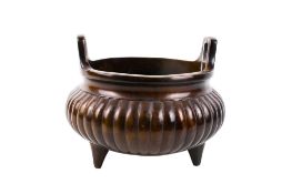 A large Chinese bronze tripod censer.