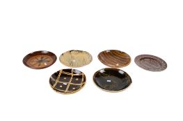 A collection of six assorted studio pottery slipware plates.