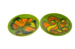 A pair of mid-century Poole Pottery Delphis plates on a green ground. Diameter 26.