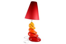 A large Francois Chatain ceramic 'stacked pebble' table lamp. Of red, orange and yellow.