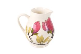 A modern Moorcroft Magnolia jug. On a cream ground H14.