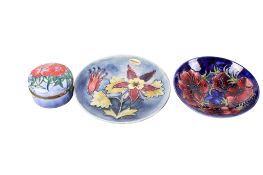 Three modern tube lined pottery items.
