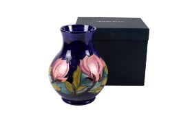 Moorcroft Magnolia vase on a blue ground, boxed.