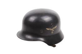 A WWII German M35 helmet. With double decals, stamped 'Q66' to the interior, lined in brown leather.