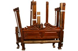 A late 20th century hardwood reproduction carved bedroom suite.