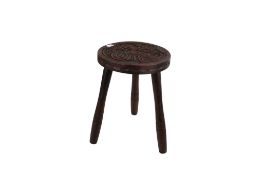 A carved wooden tripod stool. The circular top featuring a Celtic design, H35cm x Diameter 25cm.