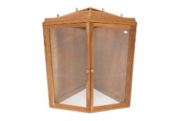 A 20th century 'Yorkshire oak' glazed corner cupboard with applied leaf decoration.