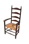 A rustic antique wooden ladderback open armchair.