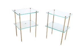 A pair of mid-century Hollywood Regency glass and brass side tables.