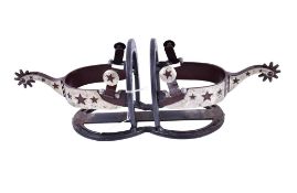 A bottle coaster made from horse shoes and spurs.