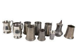 A collection of assorted pewter items mostly mugs.