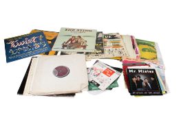 A collection of assorted vintage vinyl records. Including LPs and 7 inch singles.