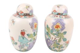 A pair of modern blush ground ginger jars and covers. Decorated with butterflies, flowers and birds.