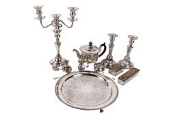A group of silver plated items and a small silver candle holder.