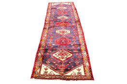 A Persian style wool runner rug.