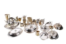 A collection of assorted silver plated items. Including mugs, entree dishes, etc.