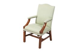 A George III style green upholstered mahogany lolling open armchair.