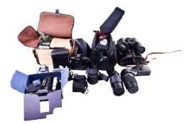 A collection of assorted cameras, lenses and a pair of USSR binoculars.