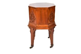 An octagonal sided carved mahogany cellarette or work box.