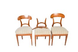 Three Biedermeier style shovel walnut dining chairs. With chequered upholstered seats, H85.5cm.