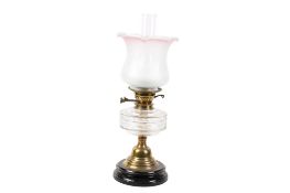 A Victorian brass oil lamp with etched shade.
