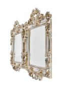 A pair of reproduction silver finish ornate rectangular wall mirrors.