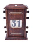 An early 20th century oak cased perpetual desk calendar.