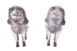 A pair of white metal Thai Singha guardian temple lions.