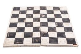 An early 20th century folding chess board. Constructed of bone and horn squares.