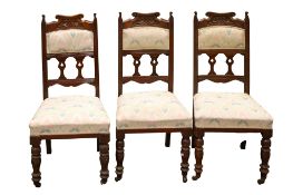 A set of three carved Edwardian mahogany chairs.