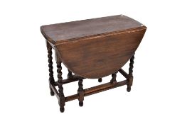 An oval topped oak gateleg table. Having barley twist supports.