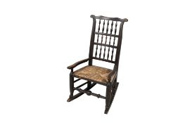 A vintage oak framed rocking chair.